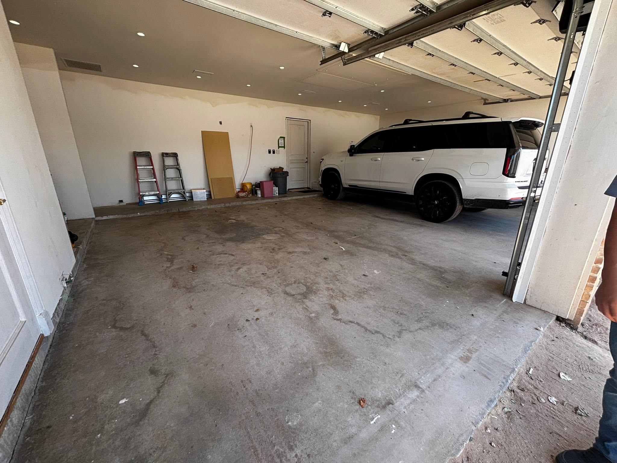 stained pitted concrete garage floor before coating in Midland, TX