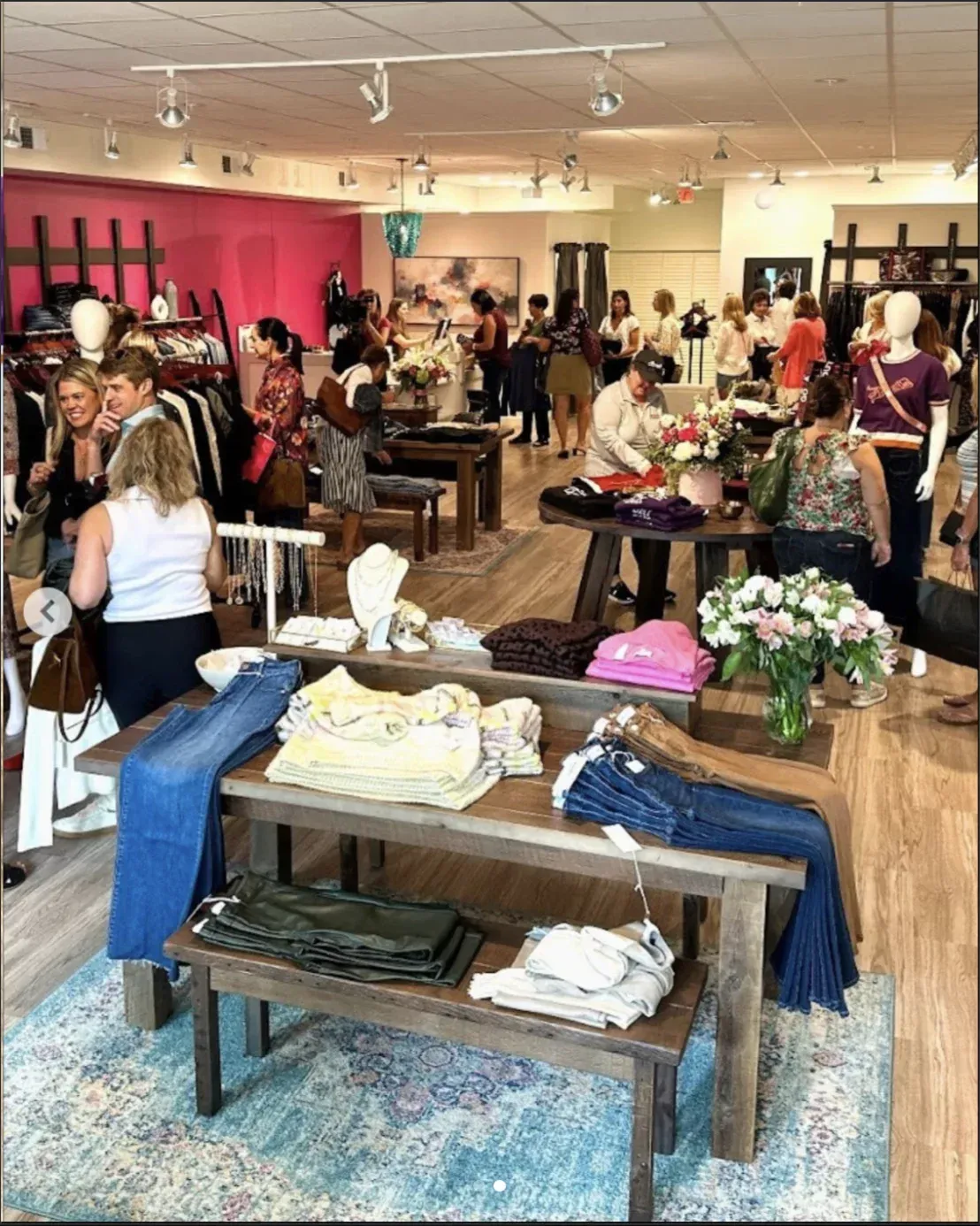 Women gathering and smiling warmly in Phoebe's boutique in Fort Mill, SC