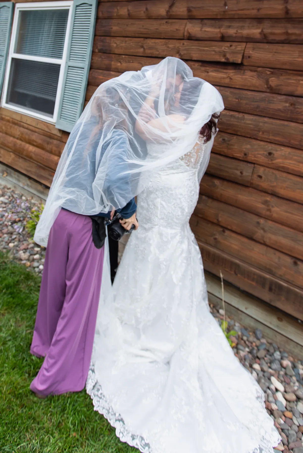 Wedding photographer helping a bride prepare for her wedding day in Minnesota