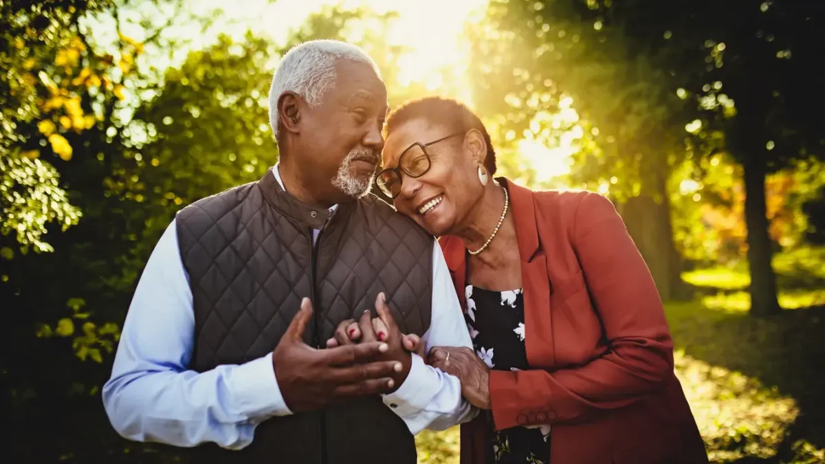 Lovely Elderly Couple Holding hands walking in the park