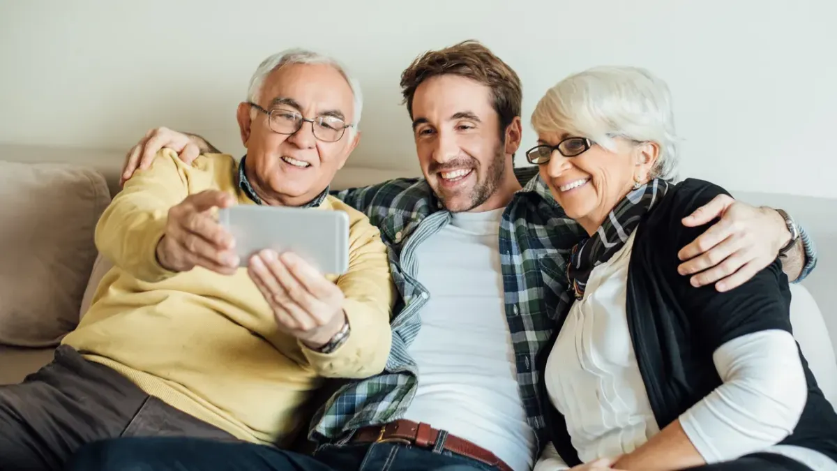 son taking selfies with his senior parents