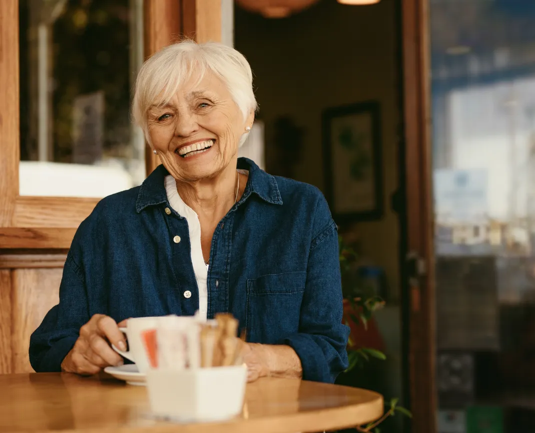 senior woman sitting at table smiling