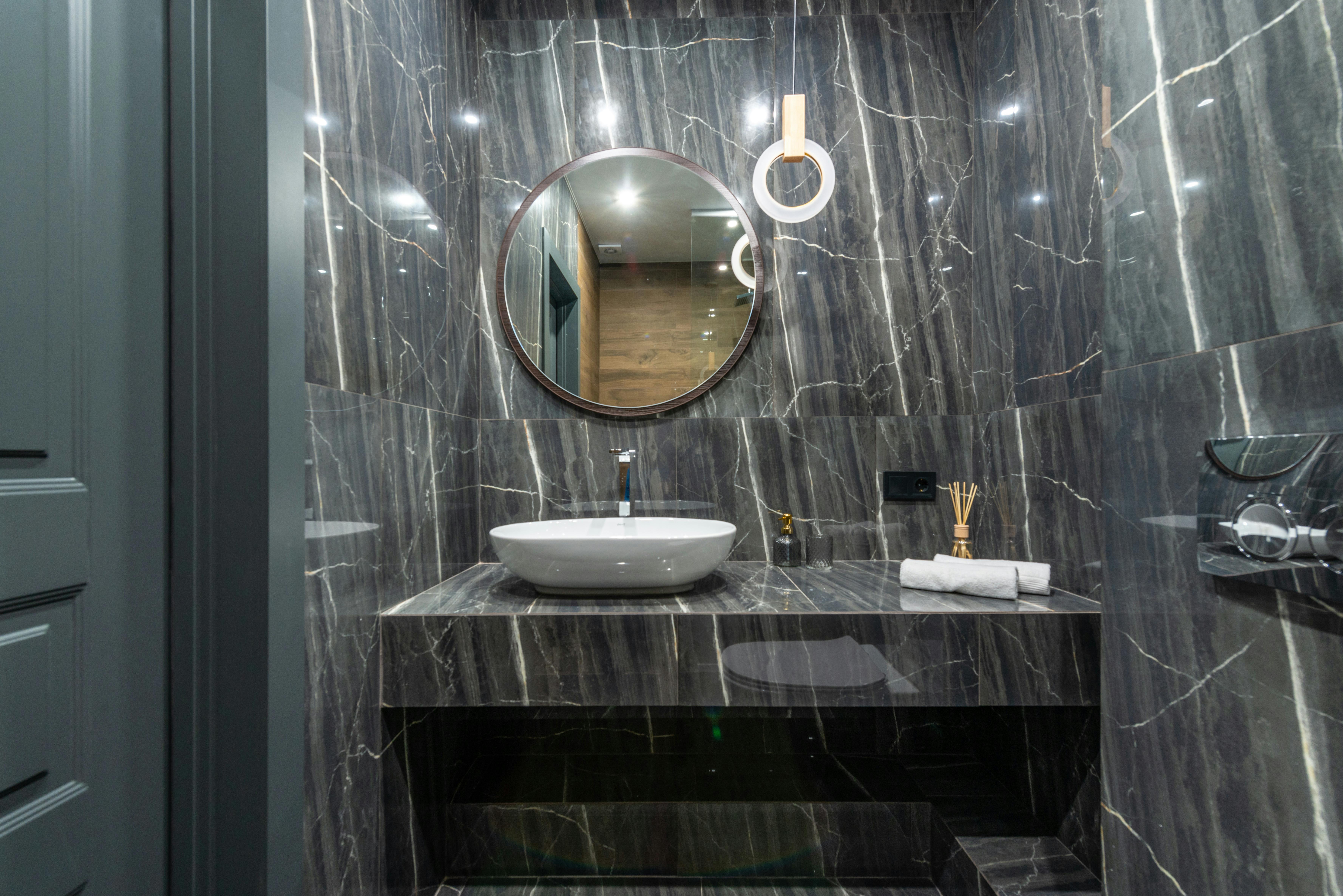 Bathroom remodel featuring curbless walk-in shower with rainfall showerhead
