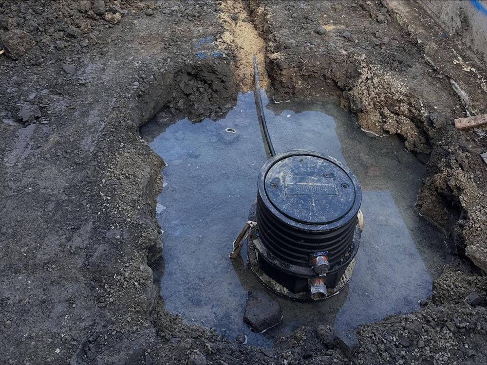 New plastic manhole inspection chamber being installed during a commercial drainage repair
