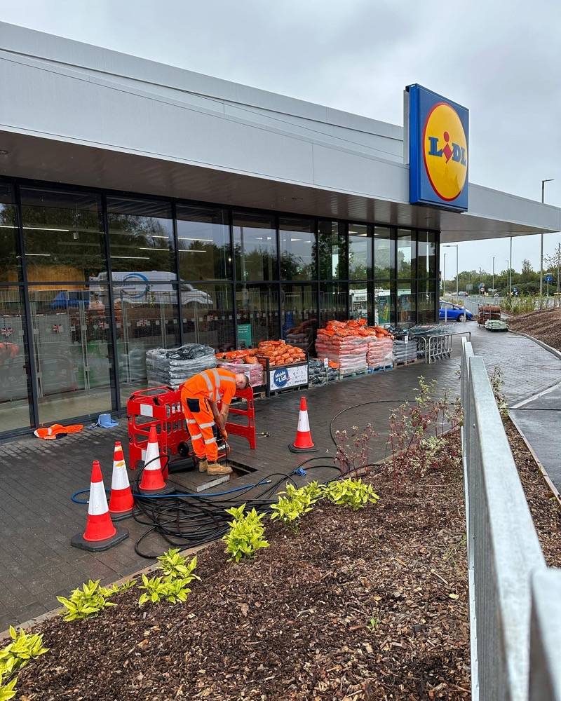 UK Drain Services worker doing a drainage job at a Lidl supermarket