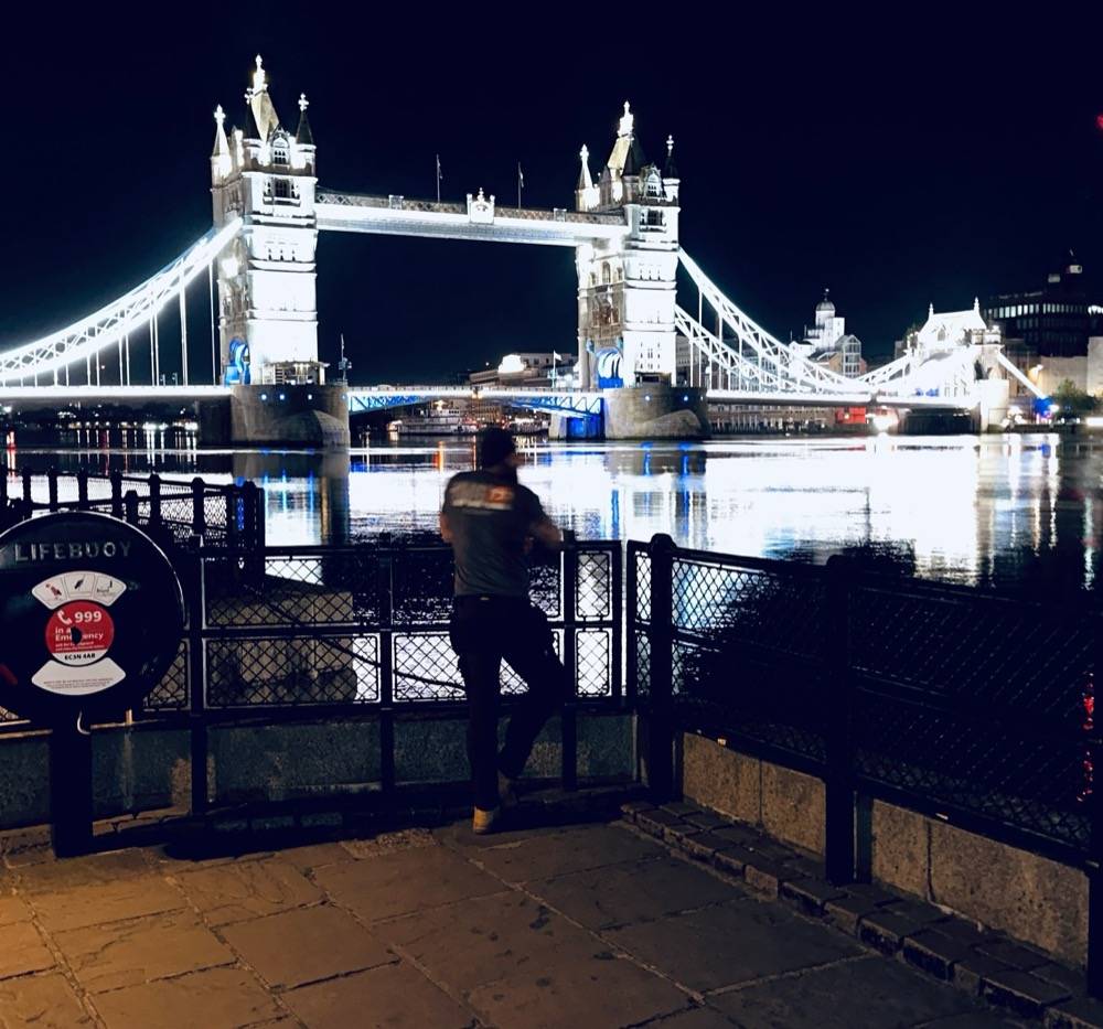 Dan from UK Drain Services in front of Tower Bridge during a drainage job