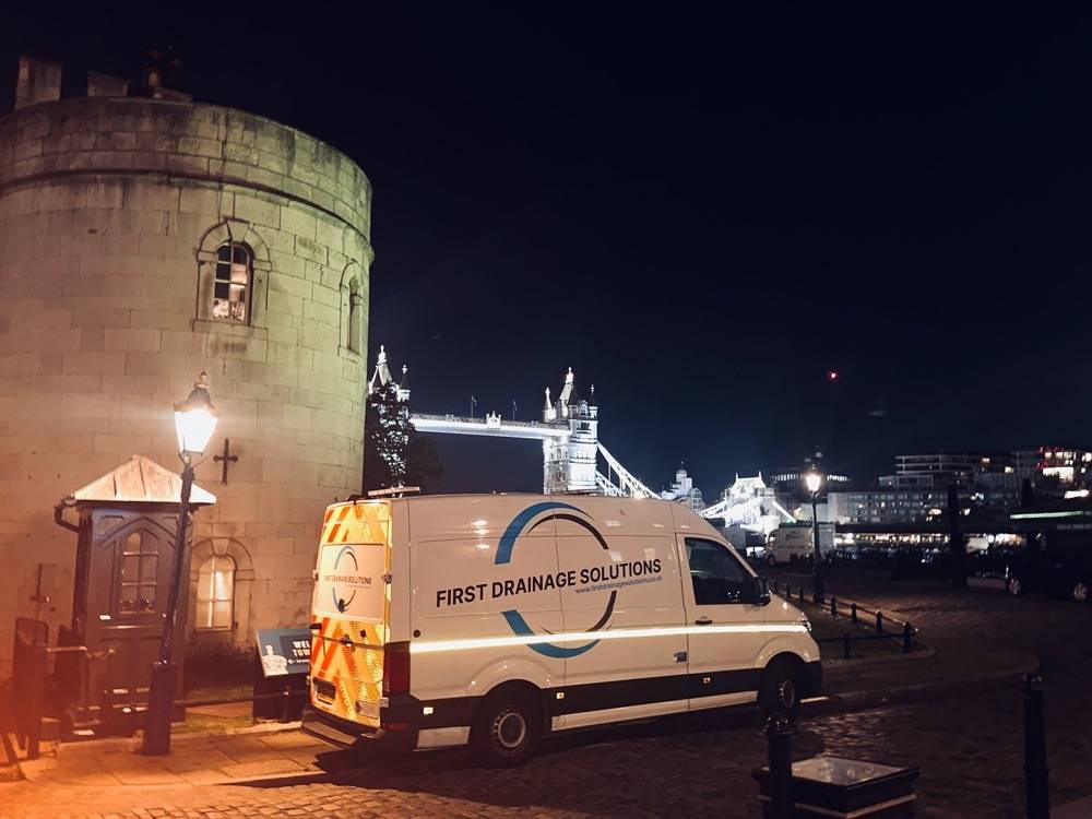 UK Drain Services van parked in front of the Tower of London during a drainage job