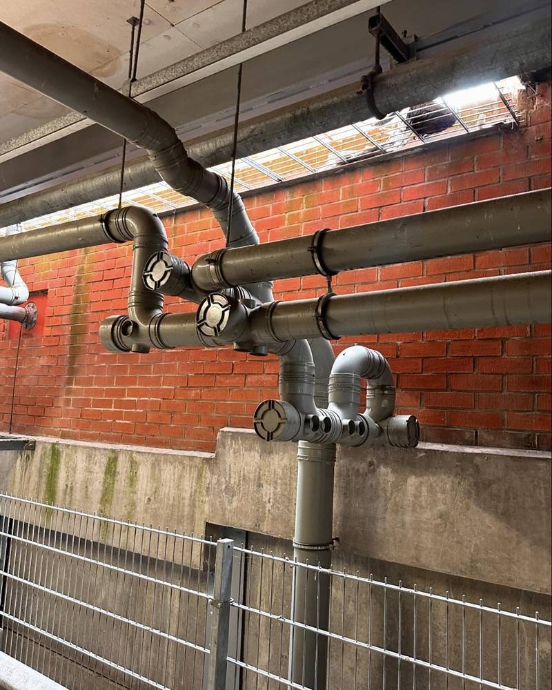 Industrial pipe junction and valve assembly in a commercial building basement