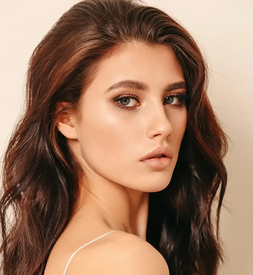 person holding clear glass bottle