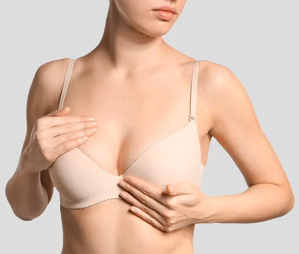 person in white dress shirt wearing green and white hat