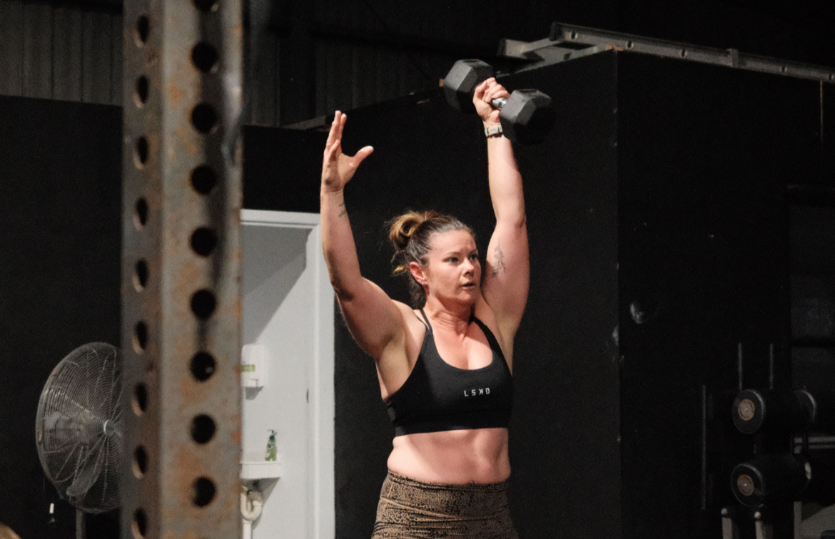 Four people practice yoga in a park.