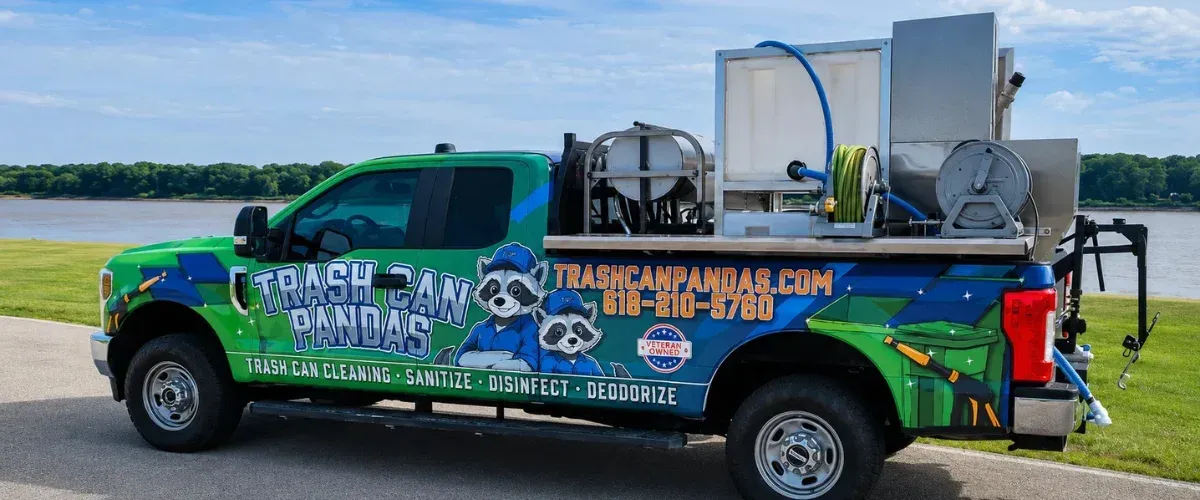 A brightly colored green and blue pickup truck from "Trash Can Pandas" with custom equipment for cleaning on the flatbed, parked outdoors.