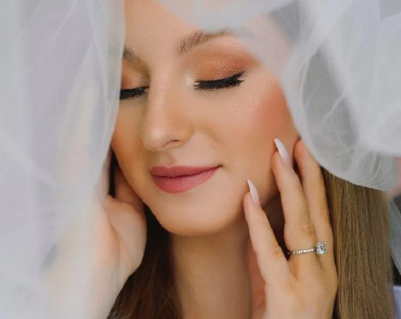 Bride under her veil with soft glam bridal makeup after her makeup trial