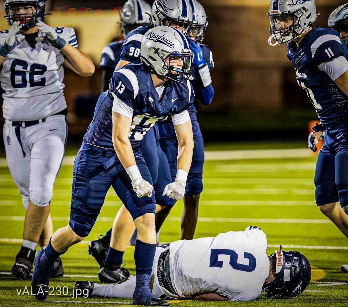 Portrait of a confident high-school linebacker standing on the field at golden hour, full-body three-quarter pose, helmet off, natural stadium light, photorealistic, crisp contrast — used as the hero athlete shot for recruitment.