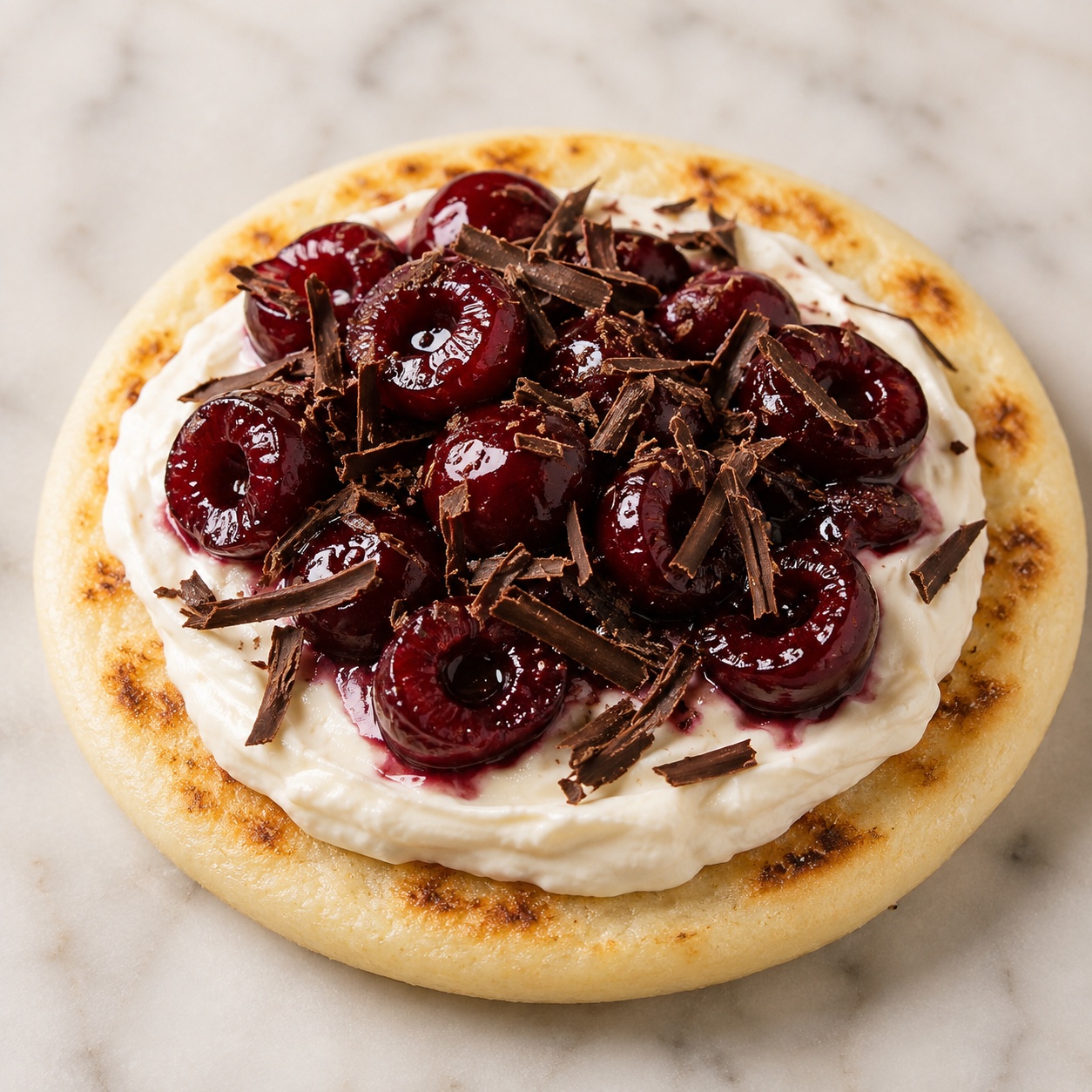 Arepa spread with mascarpone, roasted cherries and shaved dark chocolate