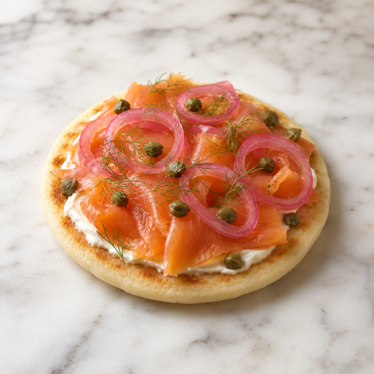 Arepa with cream cheese, smoked salmon, pink pickled onion, capers and dill