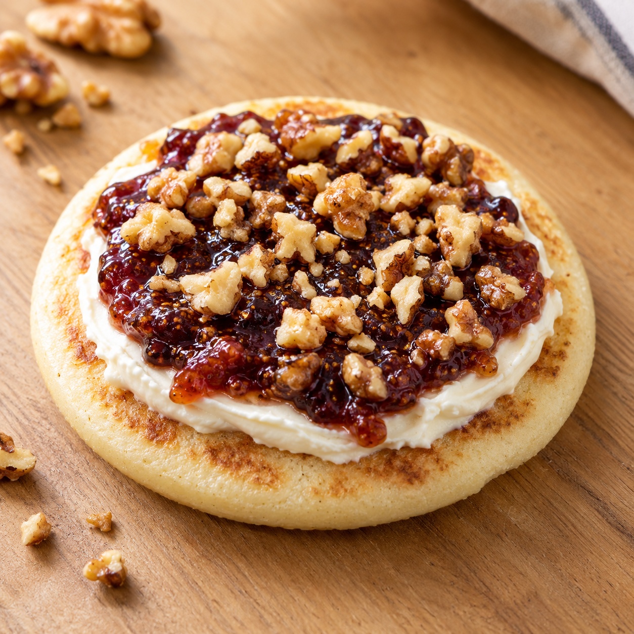 Arepa spread with cream cheese, fig jam and chopped walnuts