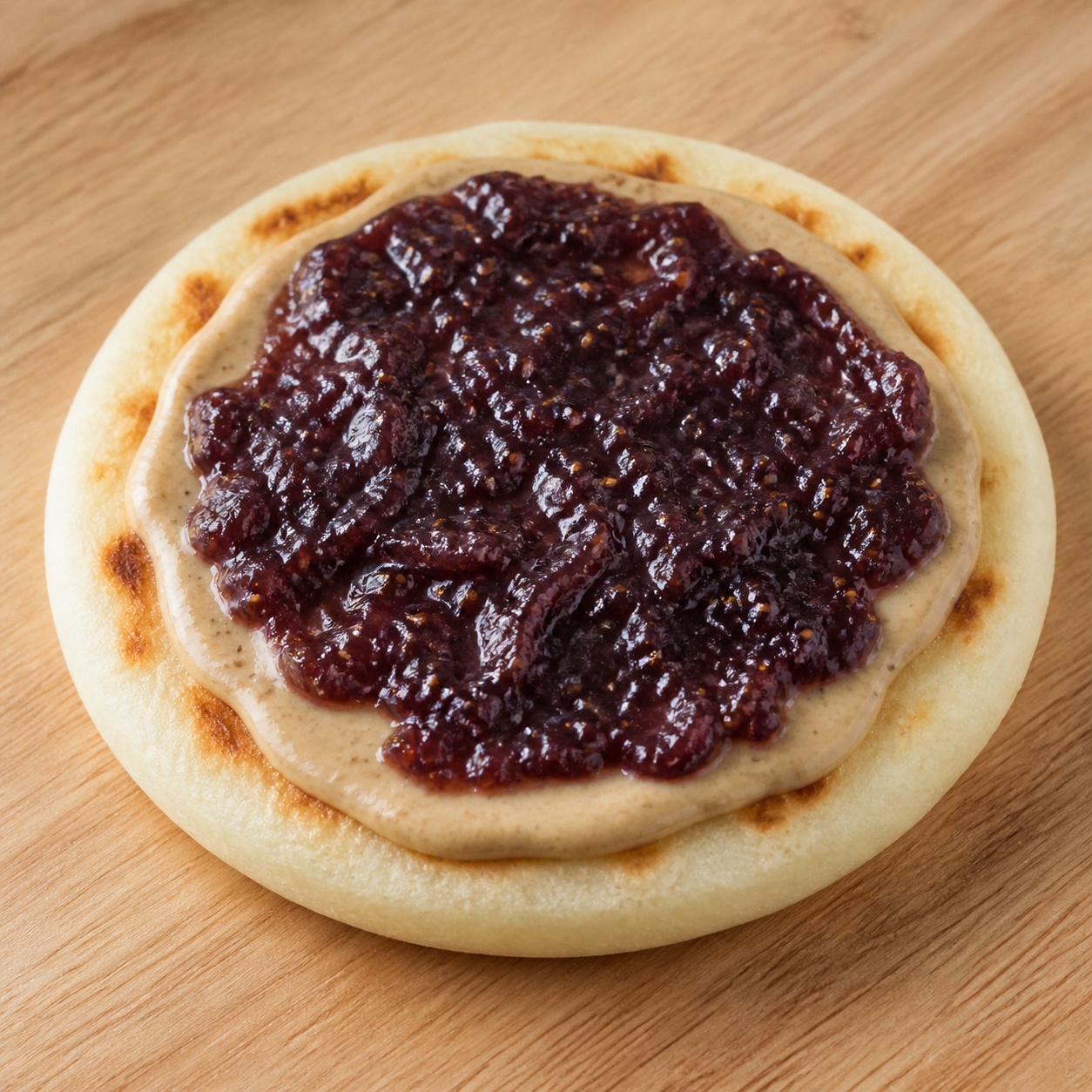 Arepa spread with cashew butter and fig jam