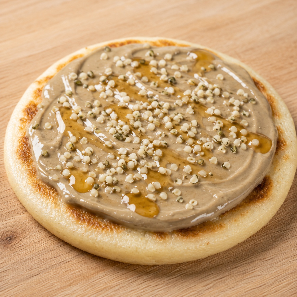 Arepa spread with sunflower seed butter, honey and hemp seeds