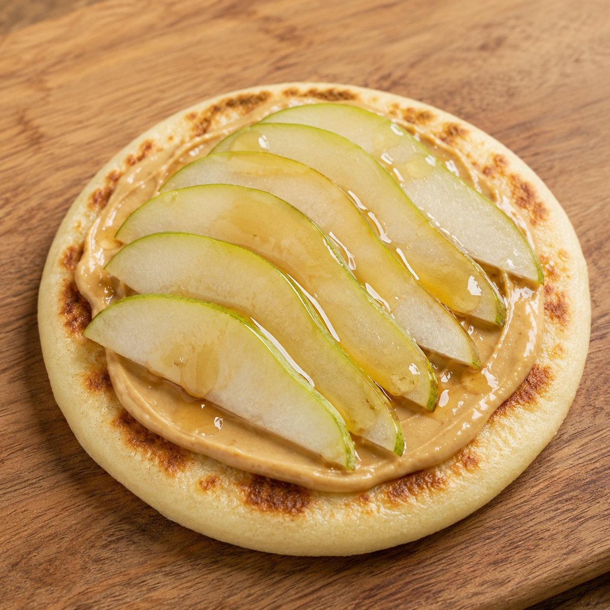 Arepa spread with cashew butter and thin pear slices