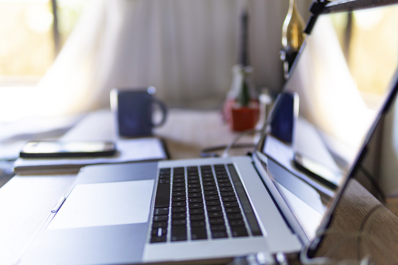 Laptop open on a desk with other various items