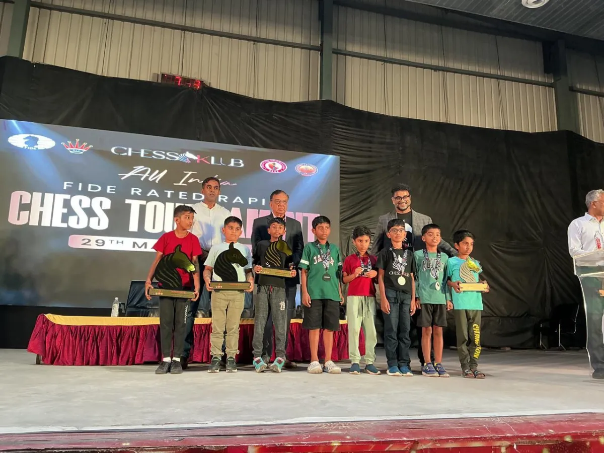 Students at CHESS KLUB with Trophies on a Stage