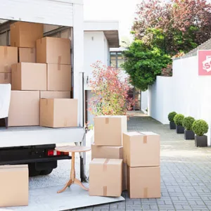 Two Men at the back of a moving truck stabalizing a full load