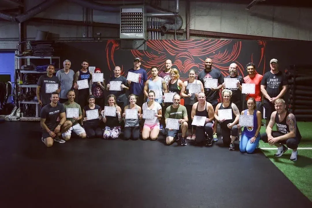 Group of certified boxing fitness coaches attending an in person boxing for fitness certification course at Onnit in Austin, Texas taught by Tony Jeffries.