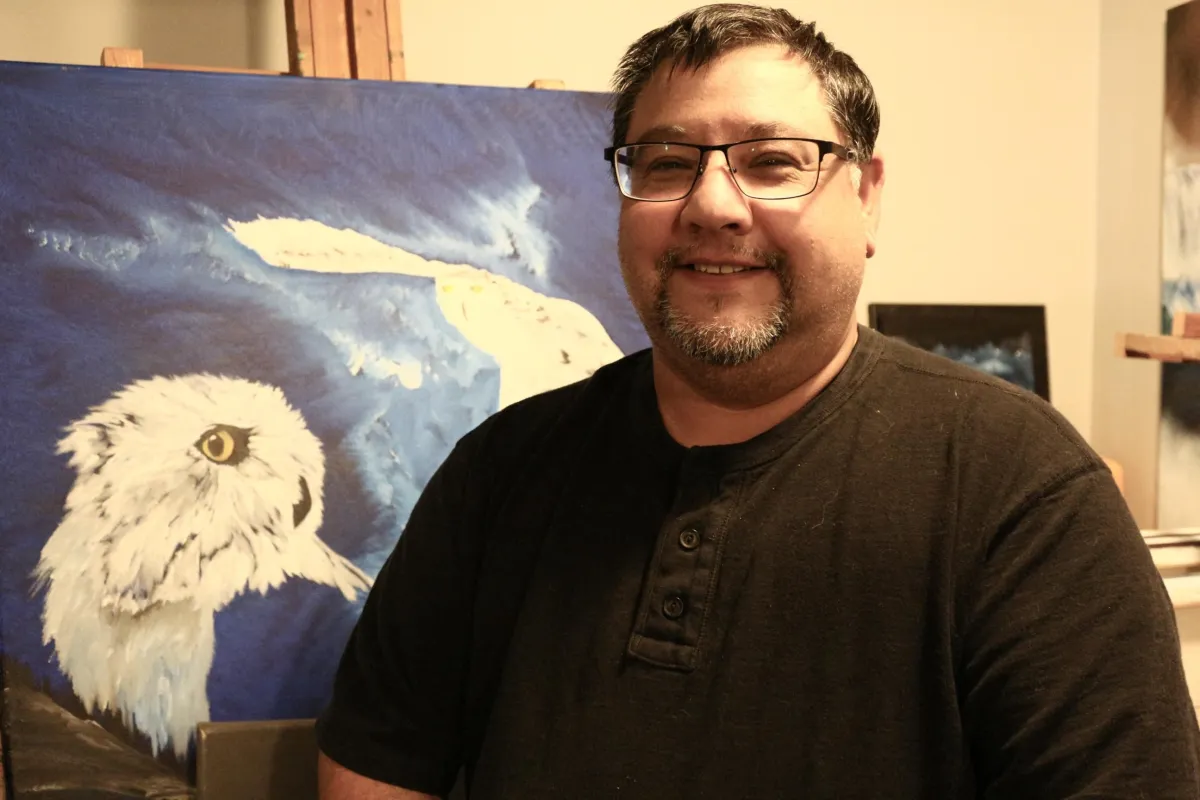 Connor with owl painting in the background