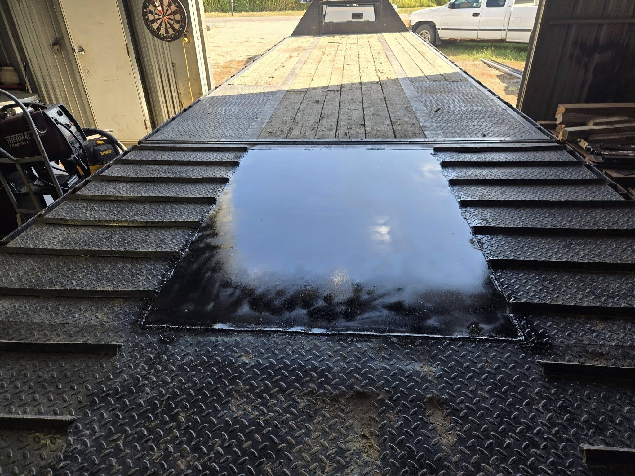 Rows of shiny metal components on a textured surface.