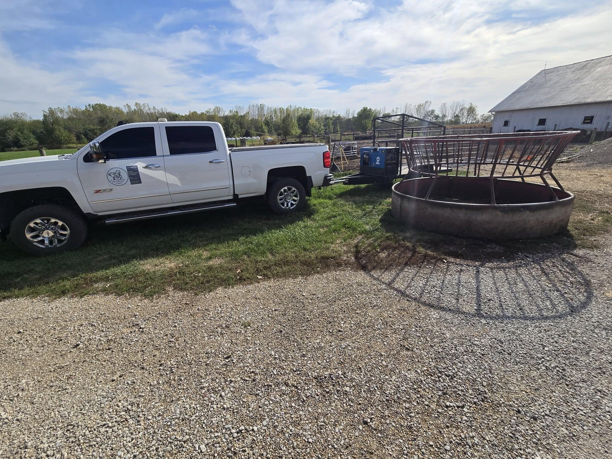 a man in a black jacket working on a piece of metal