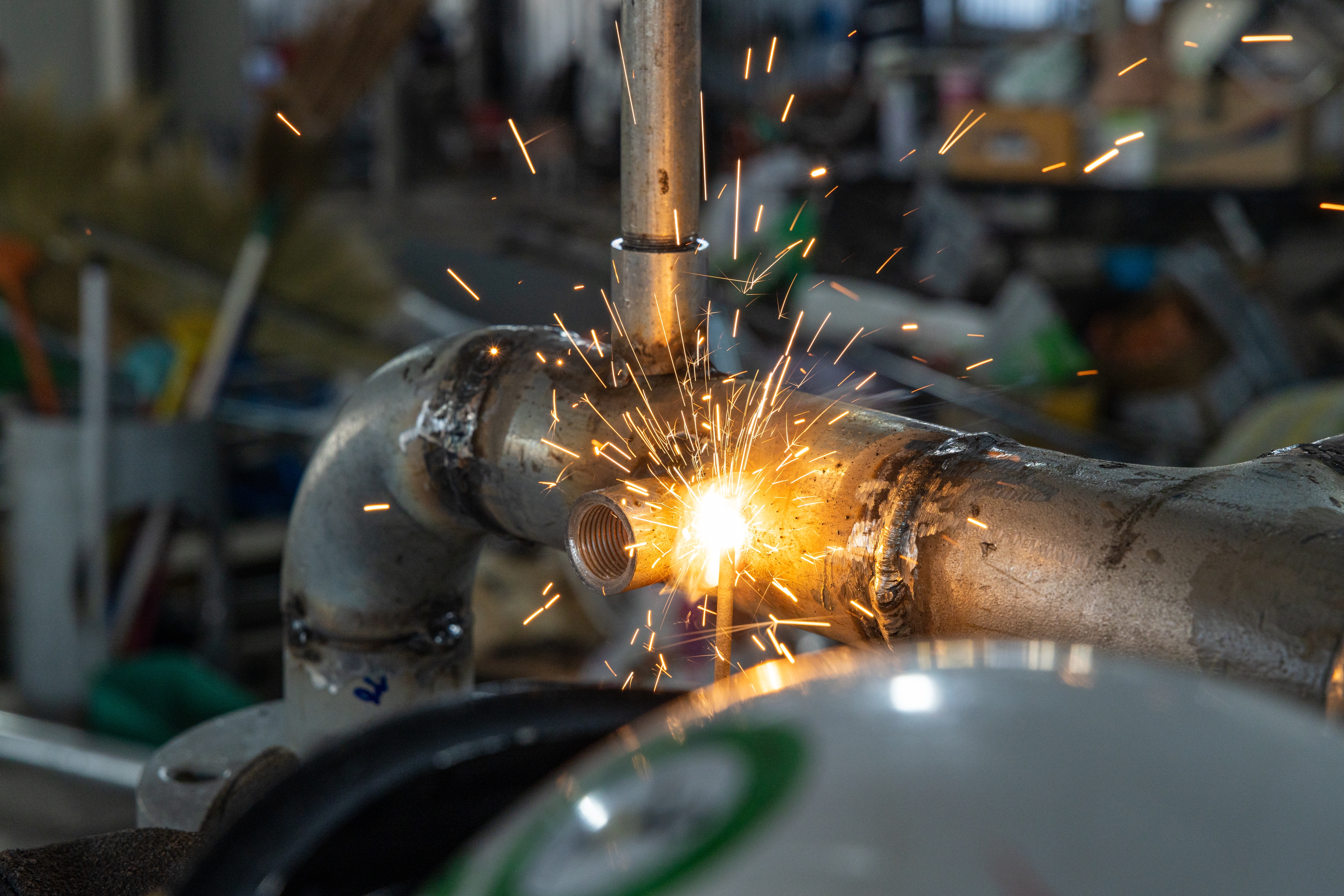 Rows of shiny metal components on a textured surface.