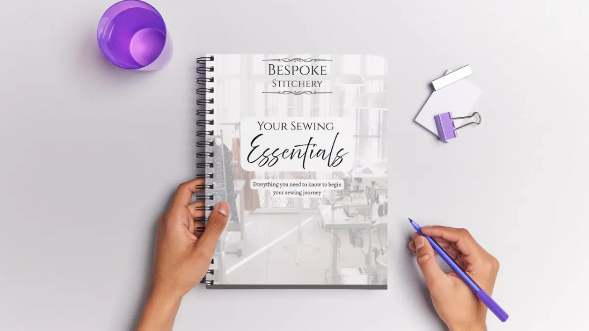 person in black pants holding white leather handbag