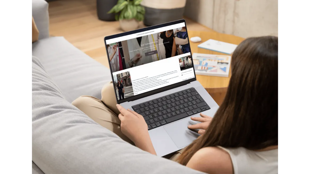 A woman with a laptop on her lap. It's open to the Your Tailored Patterns course so she can learn in her own time.
