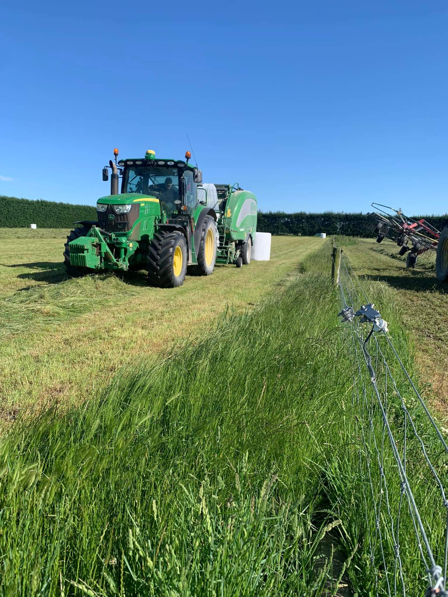 round baling tractor working paddock Christchurch Canterbury farming