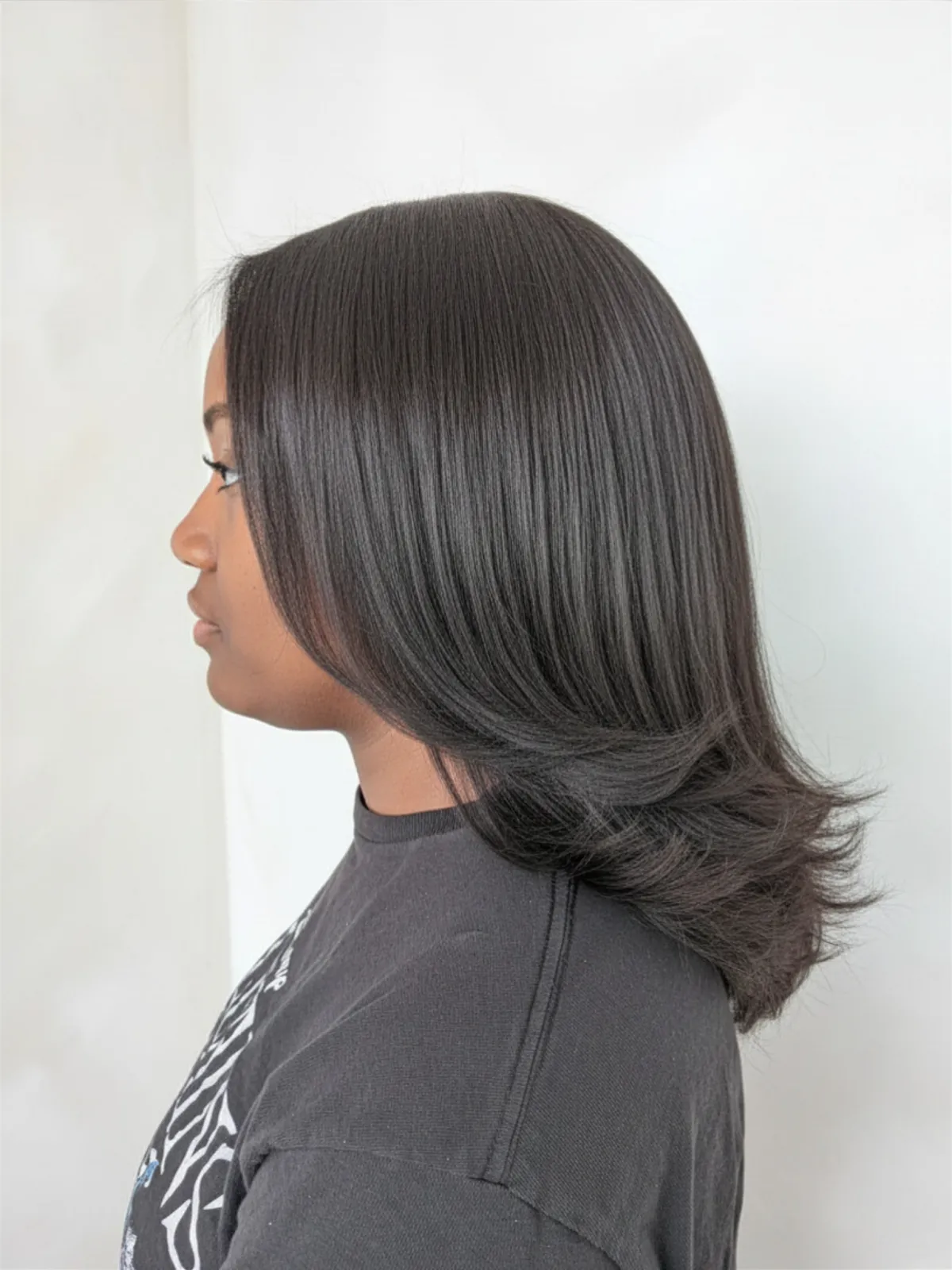 Smooth silk press on natural hair with shine, movement, and healthy ends.