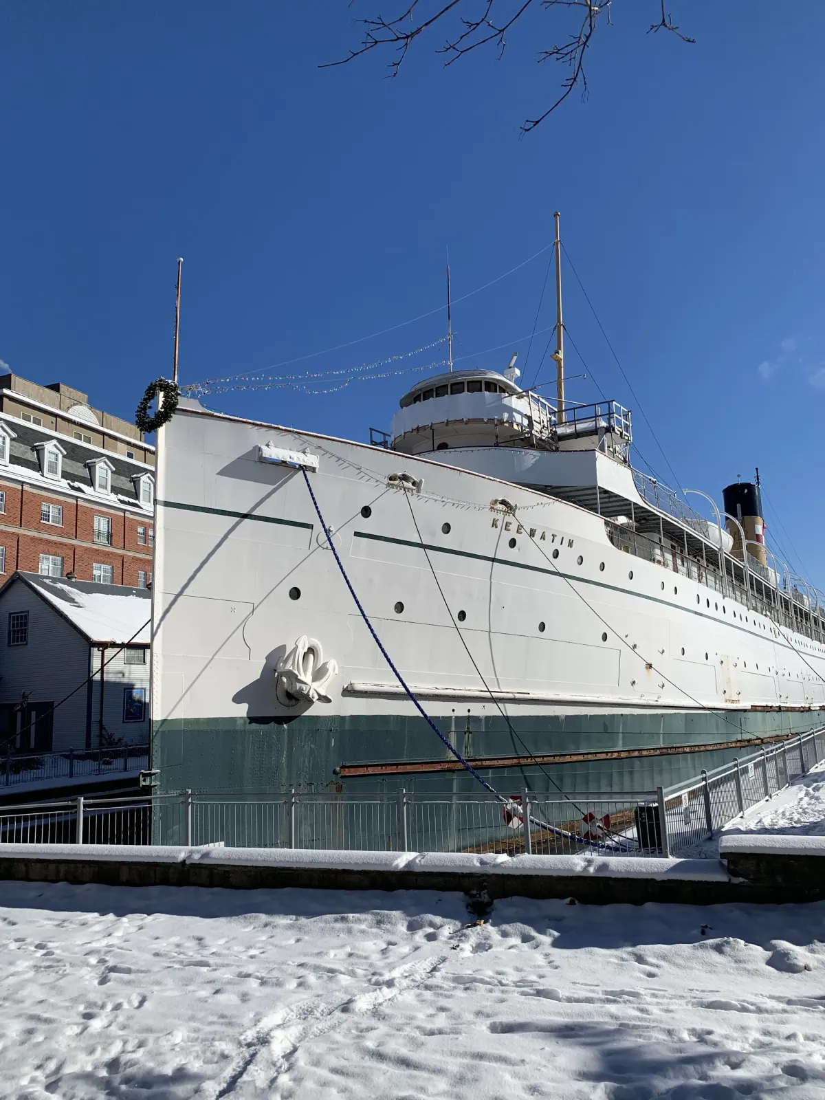 The historic steamship SS Keewatin moored at the Kingston waterfront in winter, her name visible on the bow