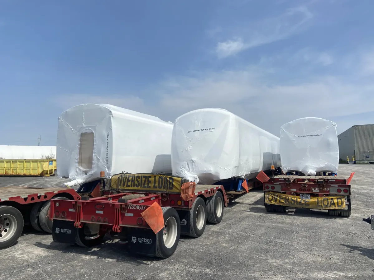 Oversized cargo shrink wrapped to reduce wind drag during highway transport