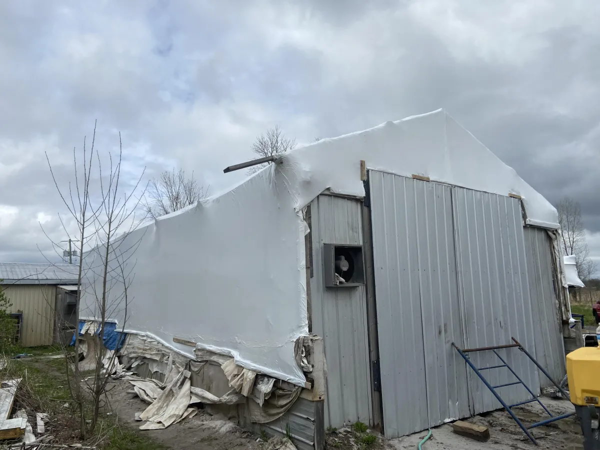 Temporary shrink wrap weather barrier on a building renovation project