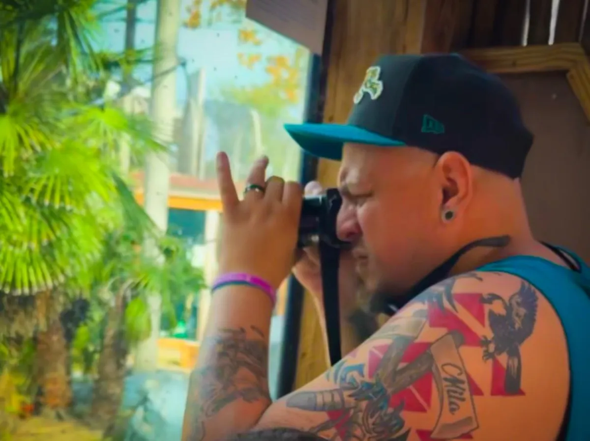 Professional photographer capturing a small business owner in a bright, modern workspace, with natural light highlighting the subject and camera equipment visible, evoking a sense of creativity and professionalism.