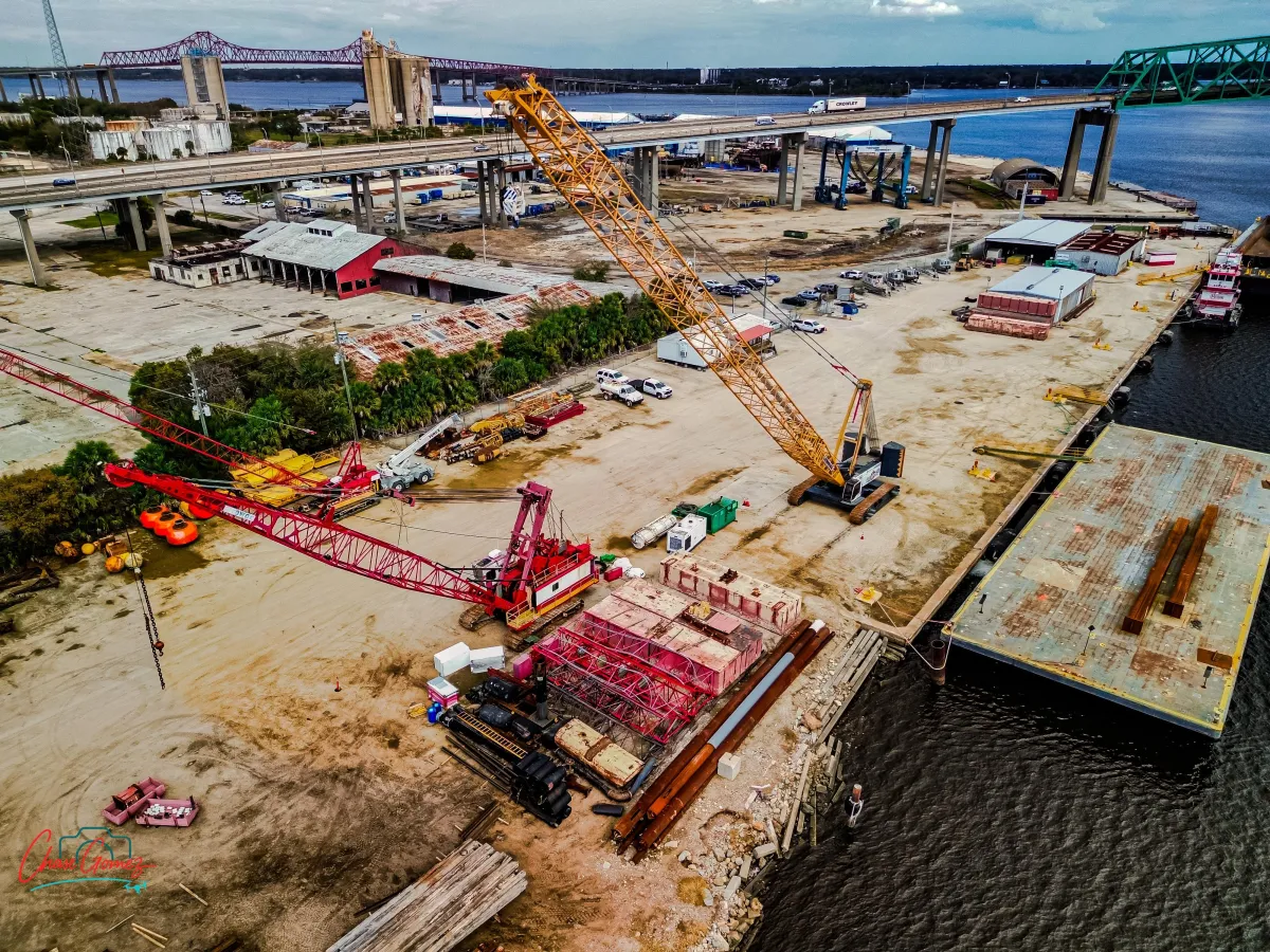 DJI Mini 3 drone flying over an industrial crane site in Jacksonville