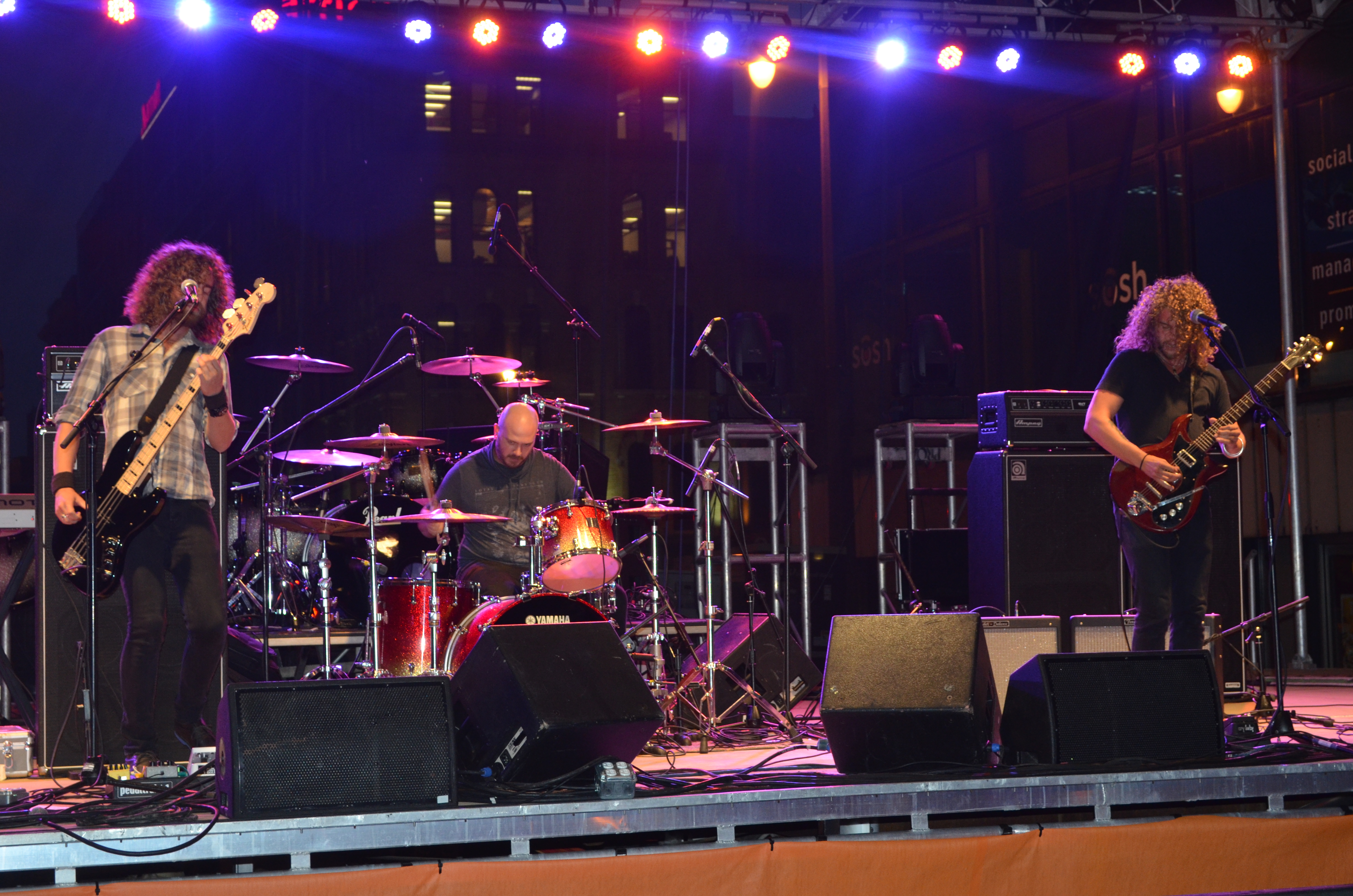 A lively birthday party scene with people of various ages dancing under colorful lights, confetti in the air, and a DJ in the background, capturing the energy and excitement of the celebration.