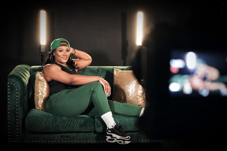 Alecia, founder of Girl Boss Academy, smiling and leading a group of women entrepreneurs