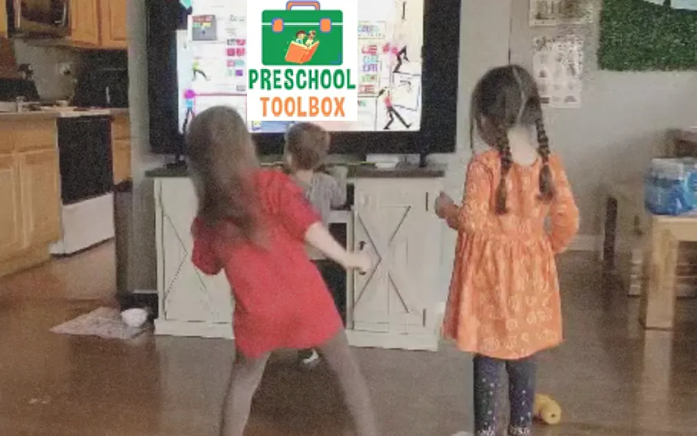 Kids moving with the teacher on a large screen TV