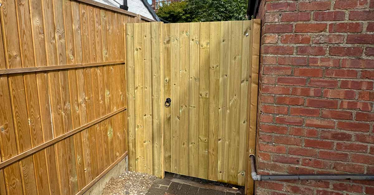 Finished custom tongue-and-groove side gate and matching infill panel, Reddish