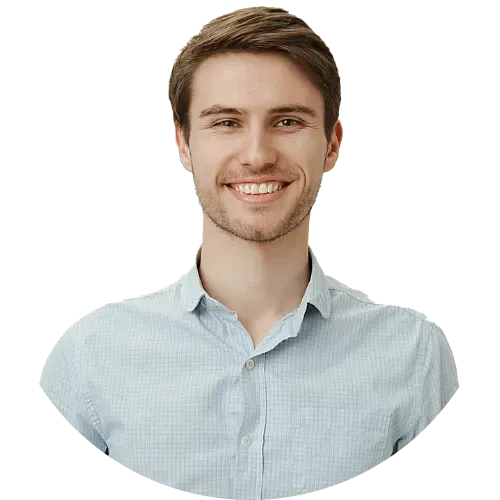 Smiling young man wearing a light blue button-up shirt.