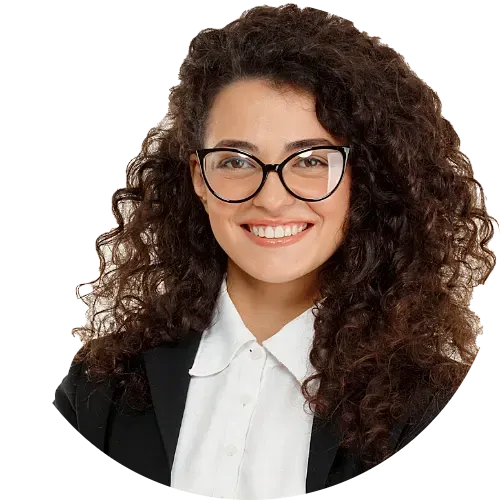 Smiling woman with curly brown hair and glasses wearing professional business attire.