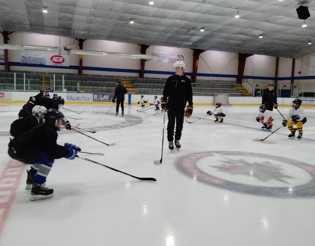 Hockey coach teaching skating