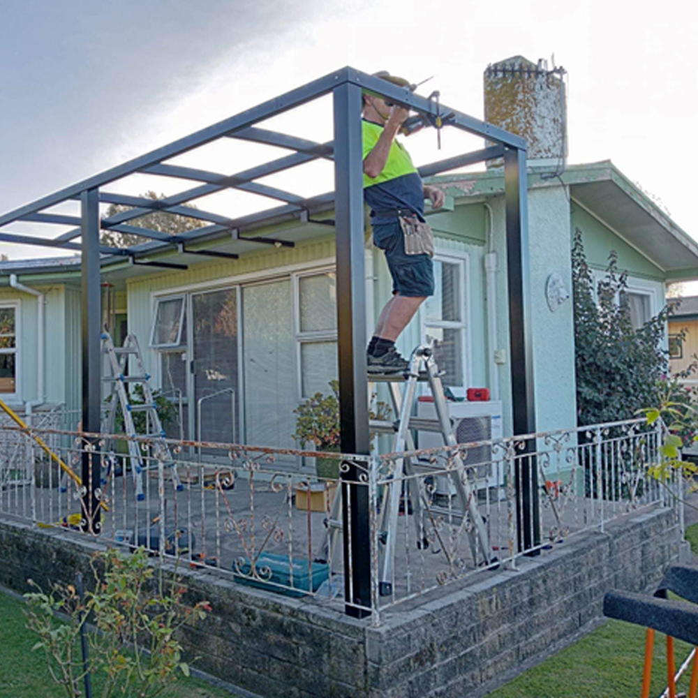 handyman fixing wooden gate in hastings
