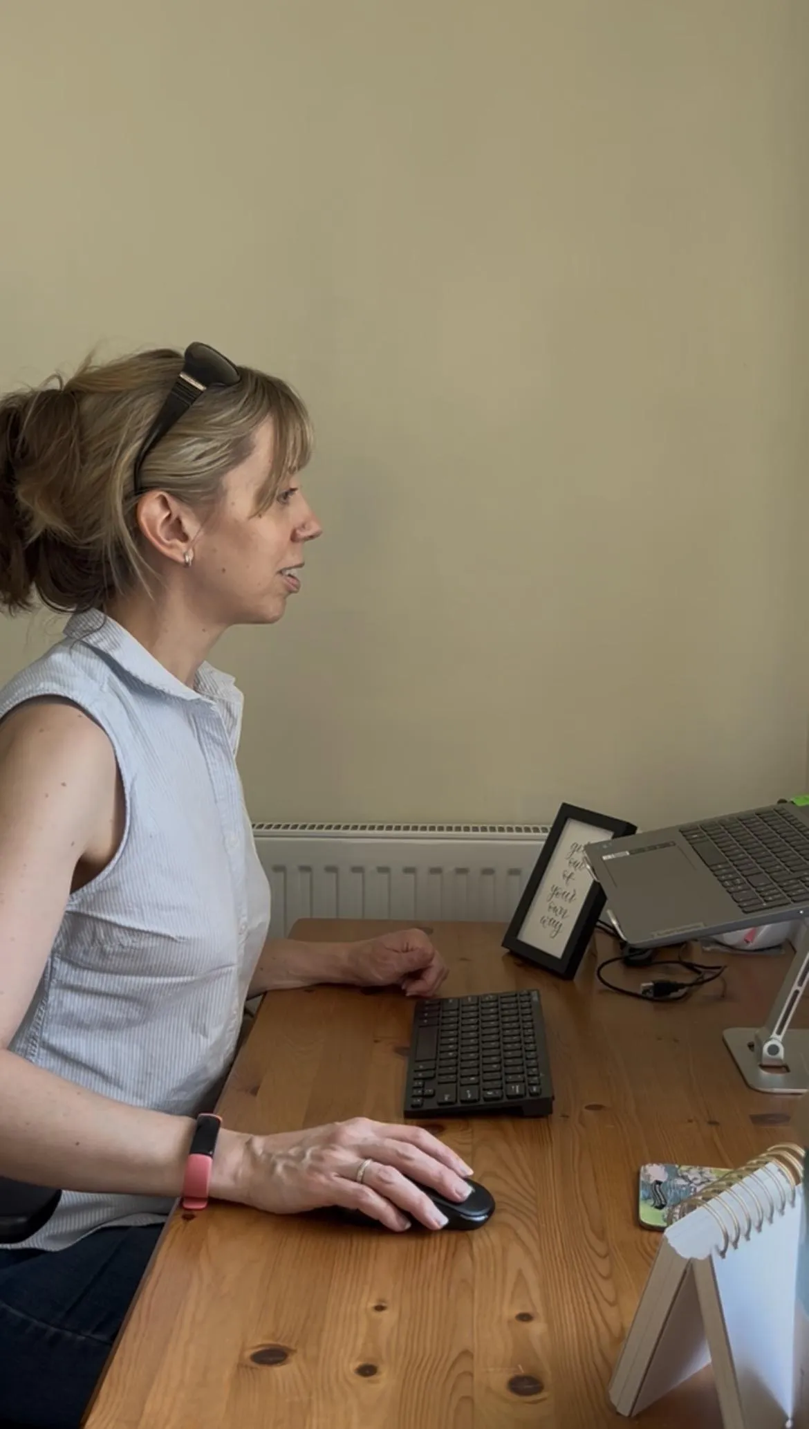 Becky at her desk, where she offers online ME/CFS coaching and gentle wellbeing support for people living with chronic illness and chronic fatigue..